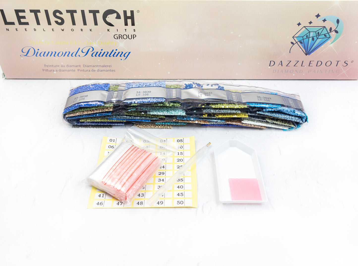 Diamond painting kit with colorful rhinestone bands and accessories on a white background.