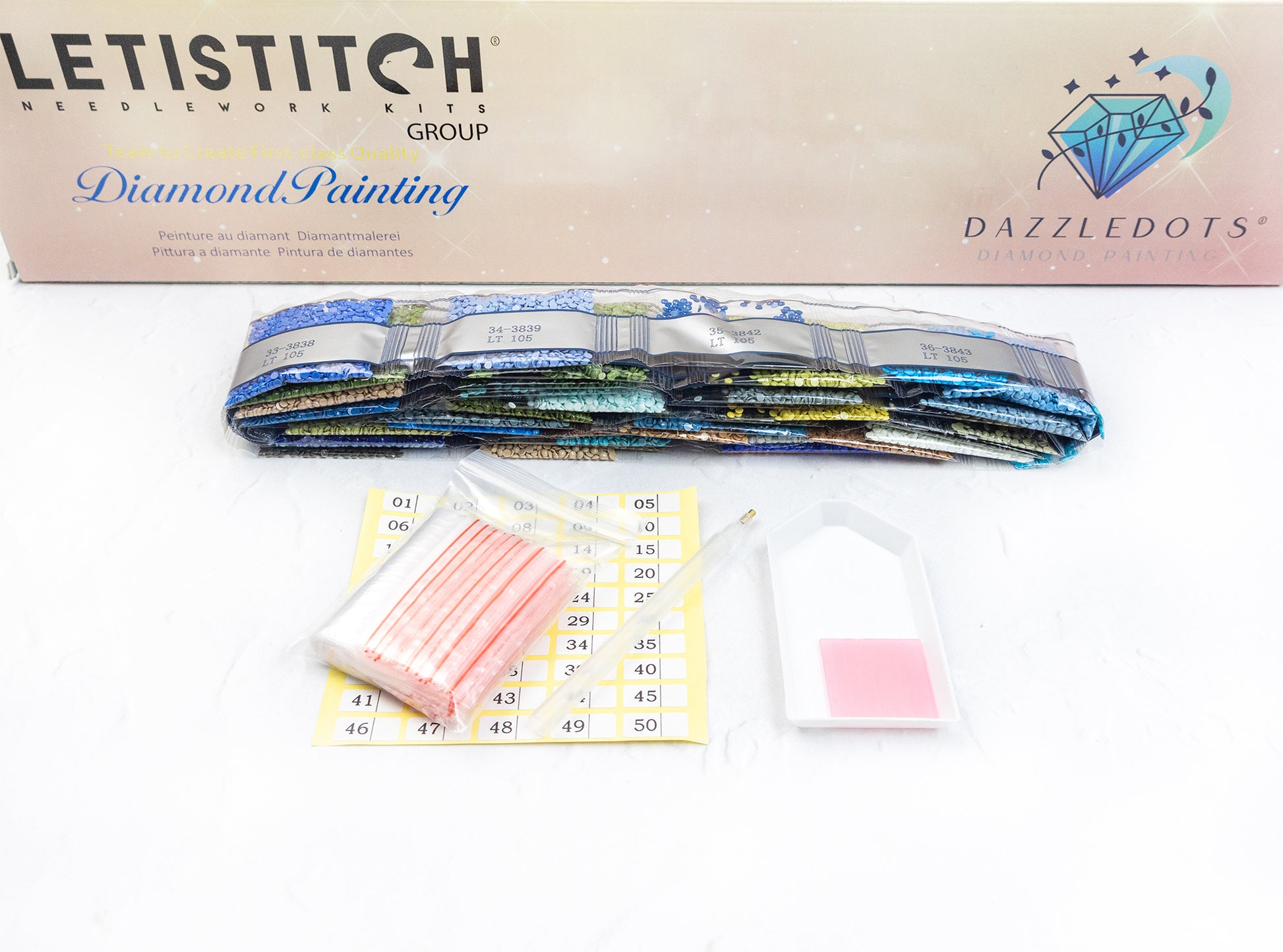 Diamond painting kit with colorful rhinestone bands and accessories on a white background.