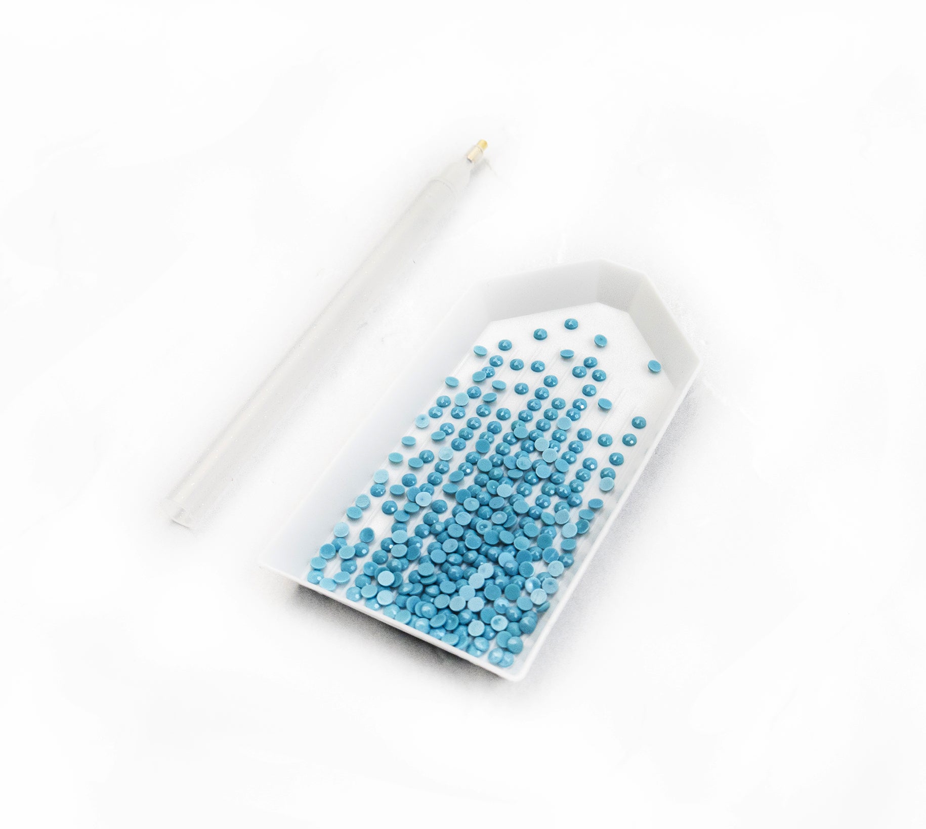 White tray with blue crystals on a white background