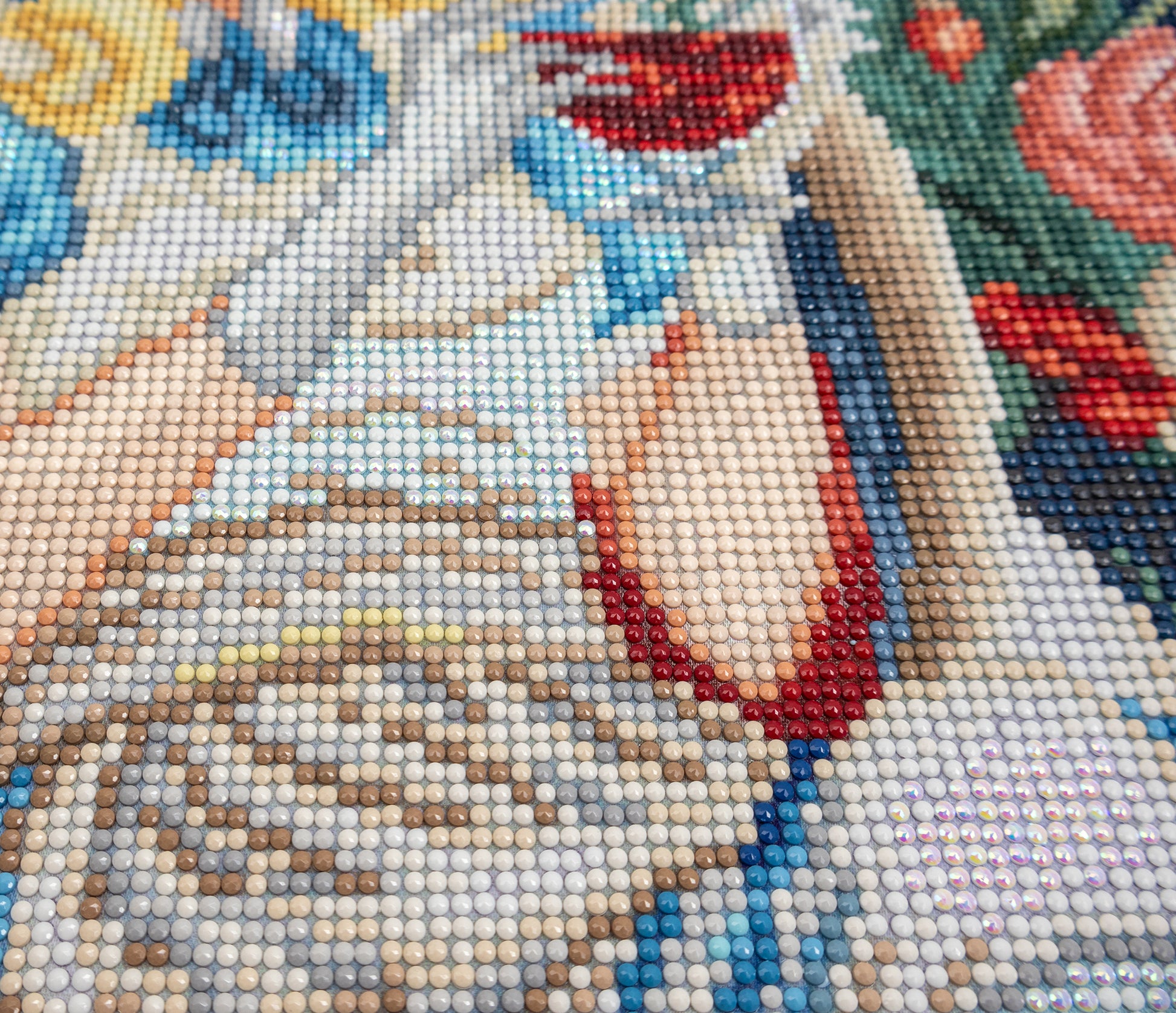 Close-up of a diamond painting with a woman's face and floral background