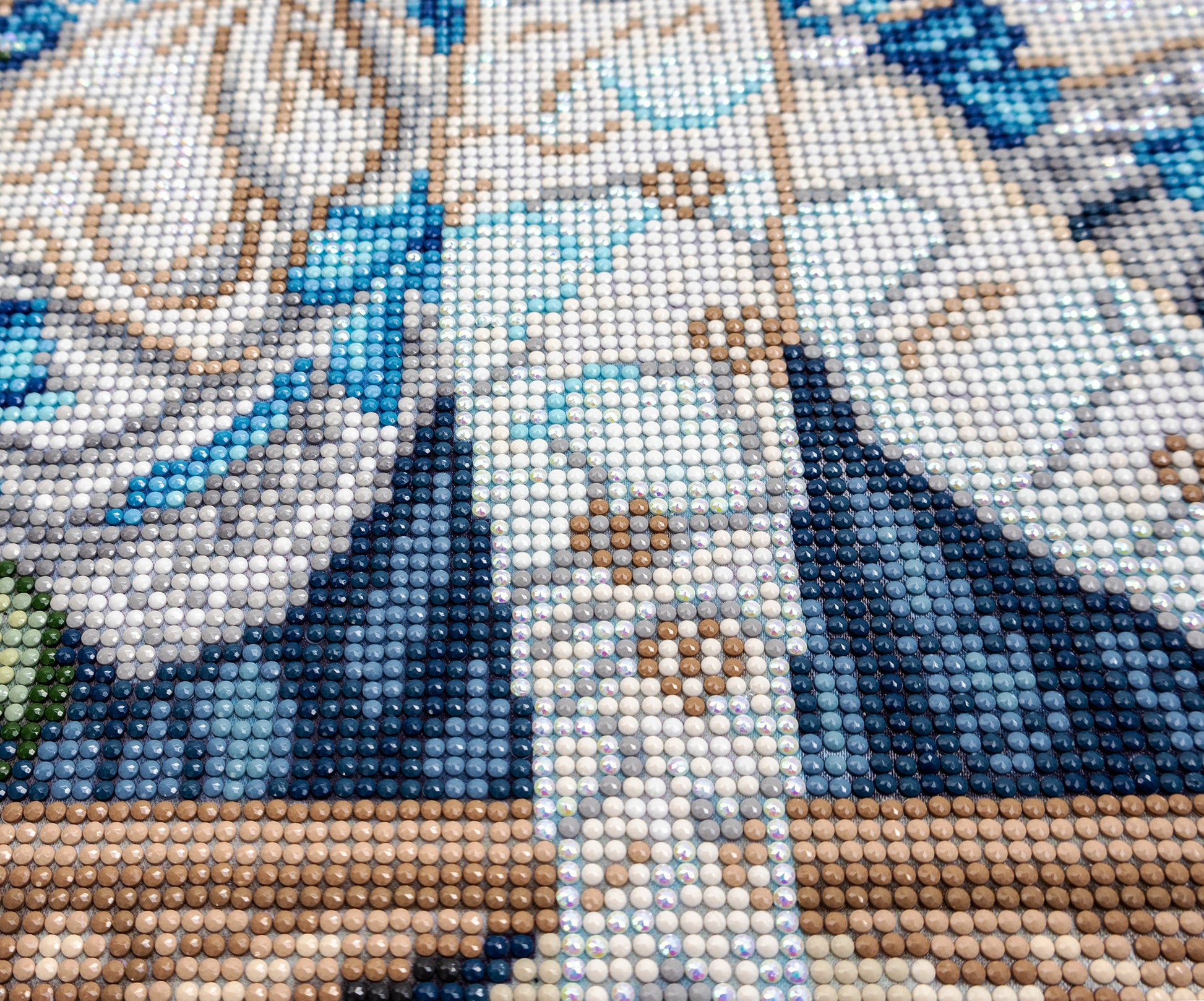 Close-up of a Diamond painting pattern with blue, white, and brown colors.