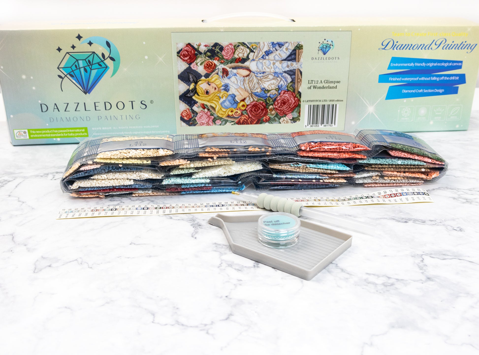 Dazzledots diamond painting kit with tools on a white surface