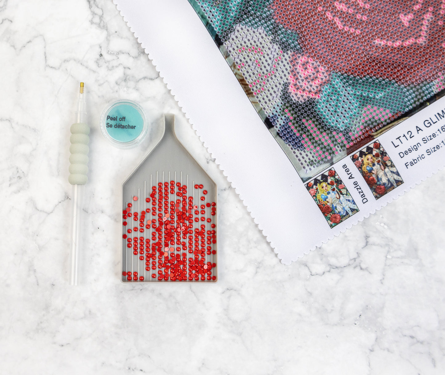 Diamond Art kit with a partially completed red rose design on a textured white surface.