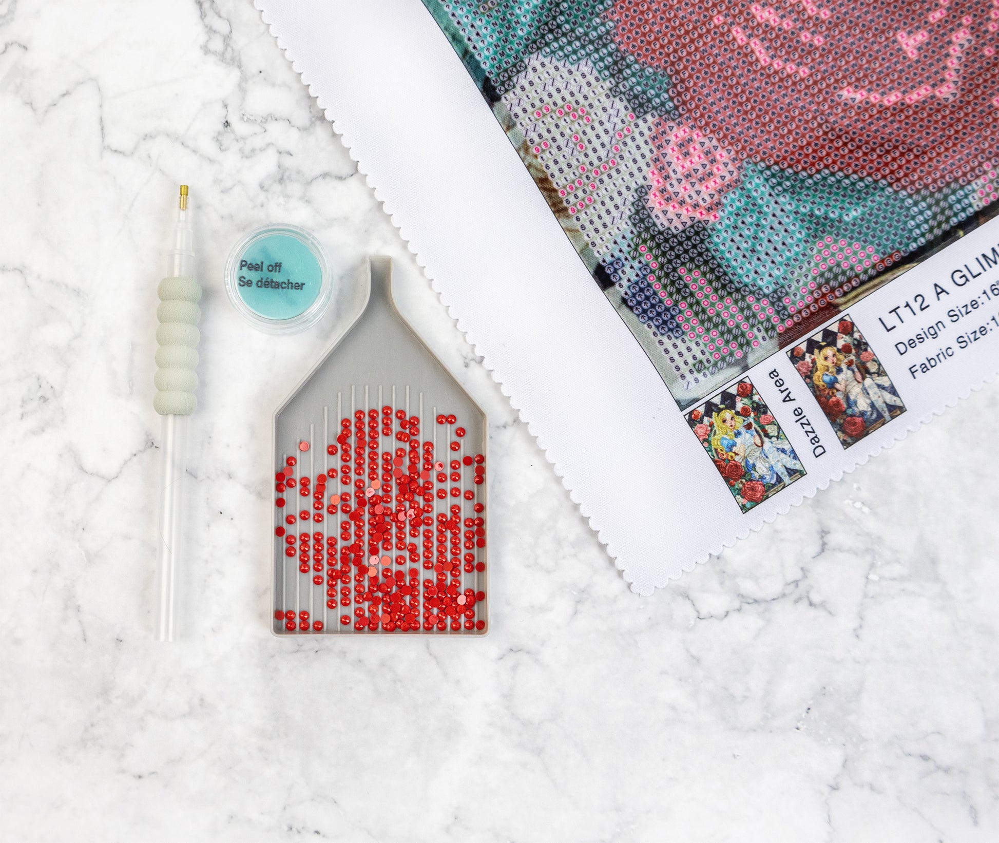 Diamond Art kit with a partially completed red rose design on a textured white surface.