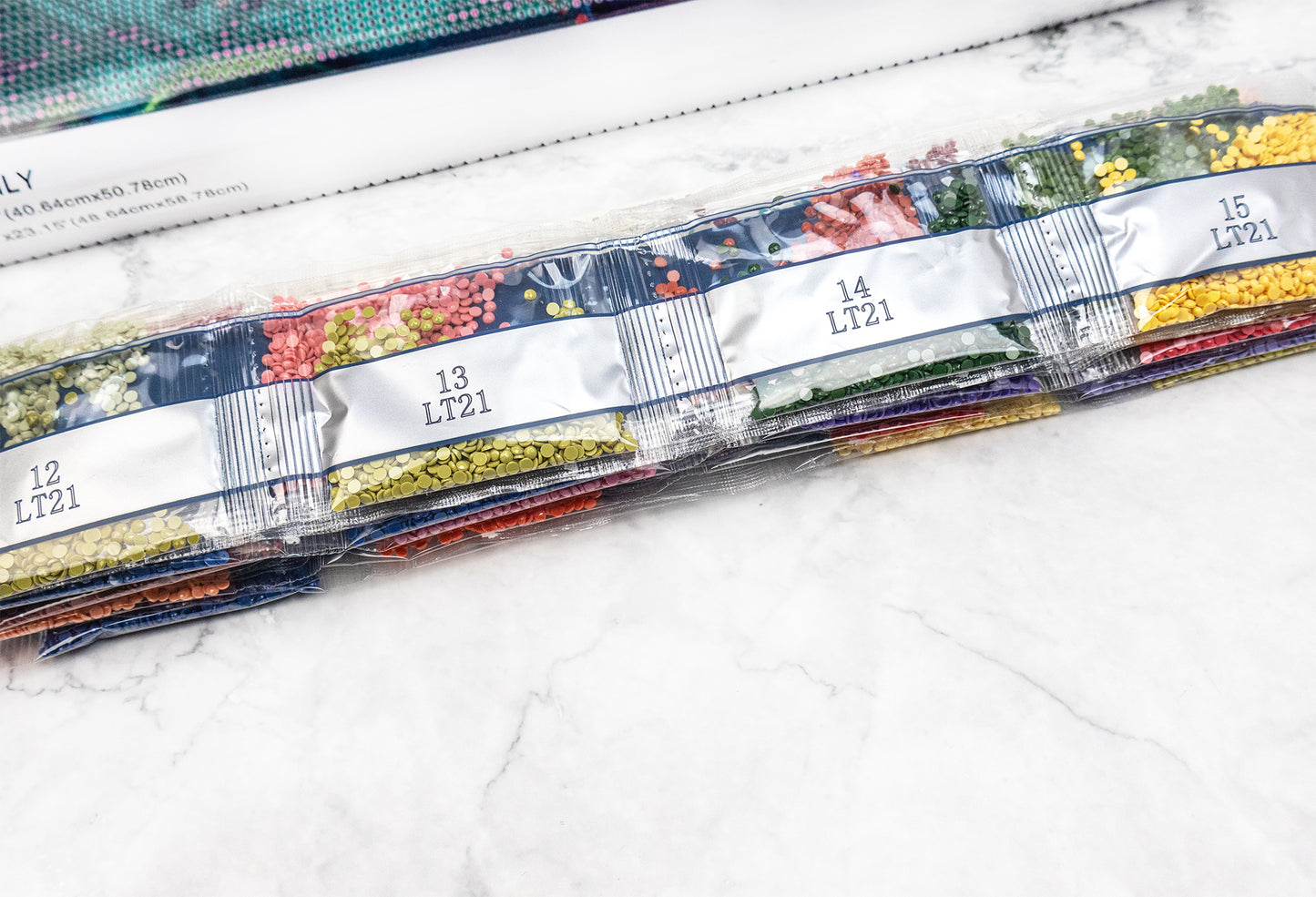 Set of colorful crystals with labels on a white surface