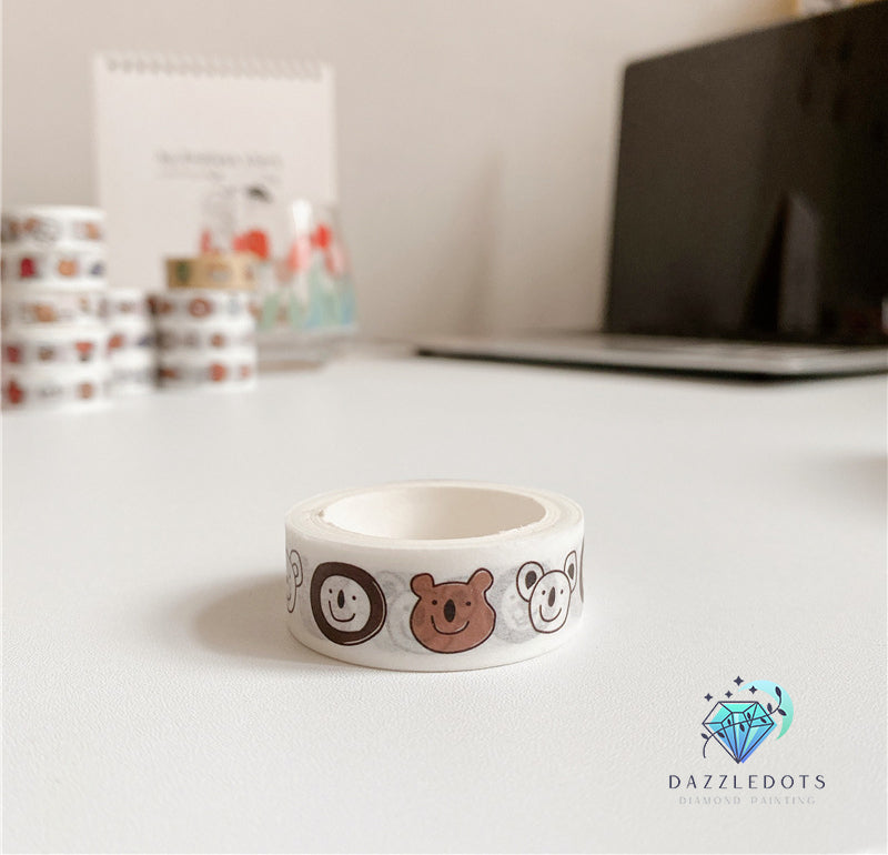 Roll of decorative tape with animal designs on a desk, featuring the brand 'Dazzledots'.